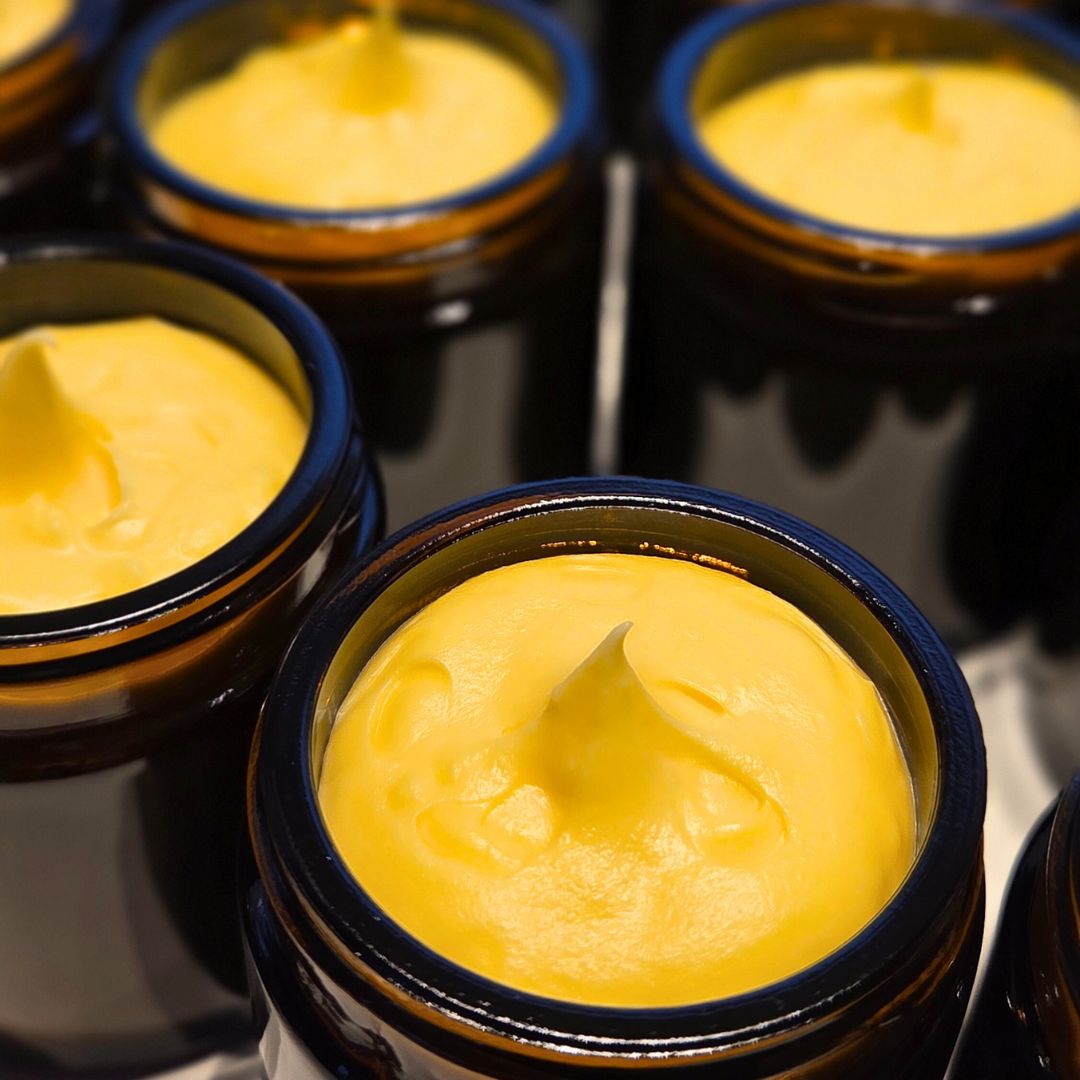 Åpne glasskrukker med gul, naturlig hudkrem laget av talg fra gressforet storfe