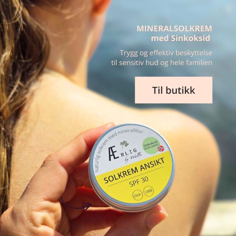 solkrem fra ærlig by walle holdes mot rygg, sjø i bakgrunn